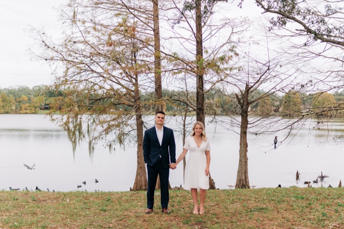Couple hold hands at Cherokee lake in Orlando after wedding 