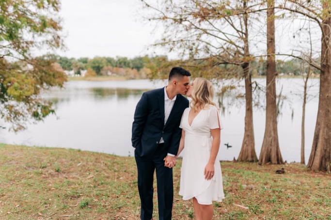 Couple Kiss at Cherokee lake in Orlando after wedding 